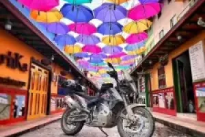adventure-bike-under-colorful-umbrellas