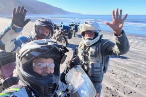 adventure-riders-celebrating-beach